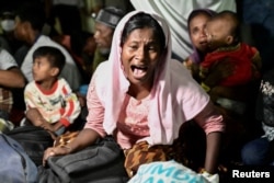 Reaksi seorang perempuan pengungsi Rohingya yang direlokasi paksa dari tempat penampungan sementara di Balai Meuseuraya di Banda Aceh, Aceh, Rabu, 27 Desember 2023. (Foto: Riska Munawarah/Reuters)